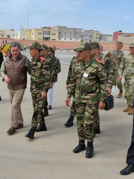 US Ambassador Duke Buchan III and Wali Ali Khalil walking with military officers